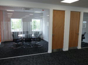 Office partitioning with large glass windows and wooden doors