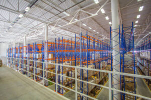 Orange and blue industrial storage racking with boxes on