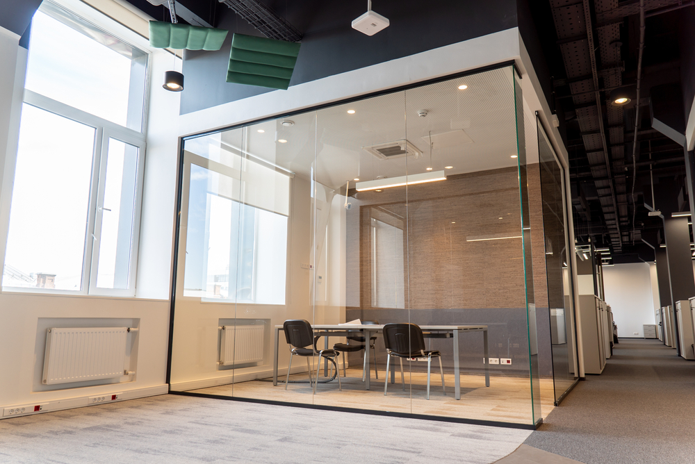 Office partitioning showing a new glass room with desk and chairs