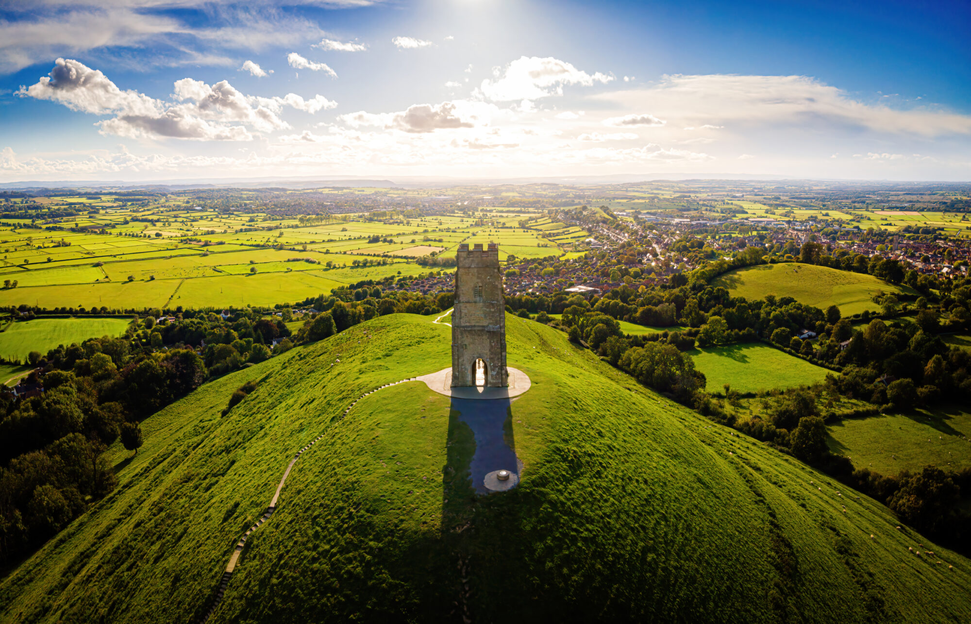 aerial shot of somerset with a castle on the hill