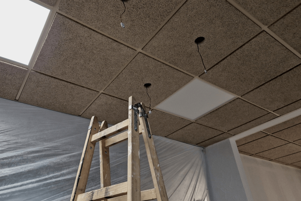 suspended ceilings with a ladder in the photo